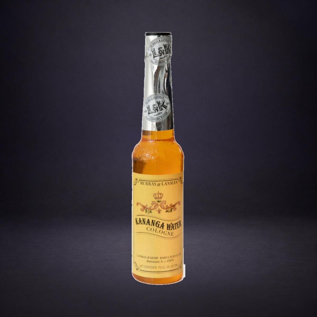 Kanaga Water spiritual cologne bottle on charcoal and purple.