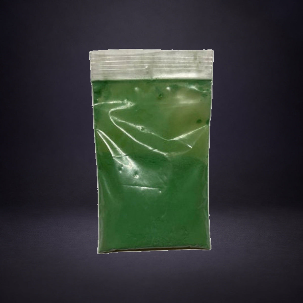 Precipitado Verde in a clear zip bag on charcoal and purple.
