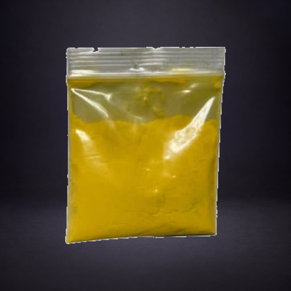 Precipitado Amarillo in a clear zip bag on charcoal and purple.