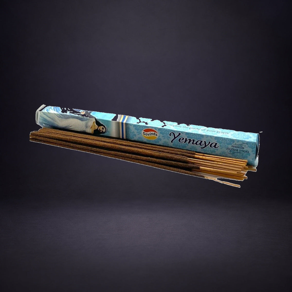 Yemaya incense package and sticks on charcoal and purple.