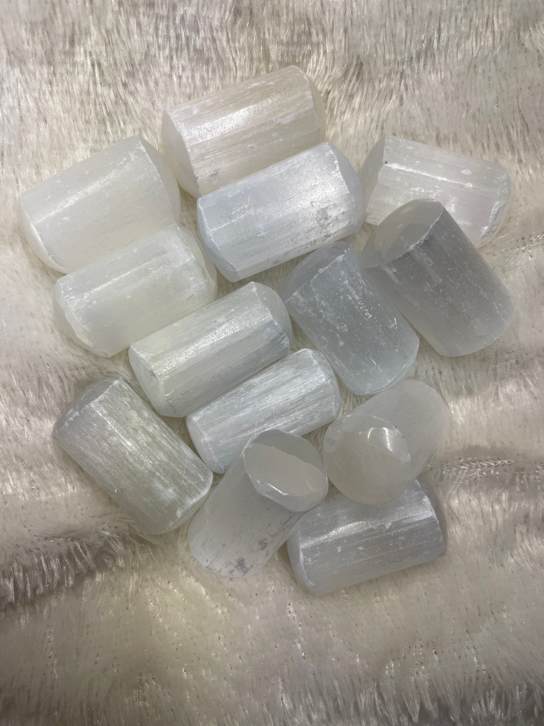 Representative pale, fibrous selenite tumbled stones from the shop’s listing; each purchase includes one approximately 1-inch stone.
