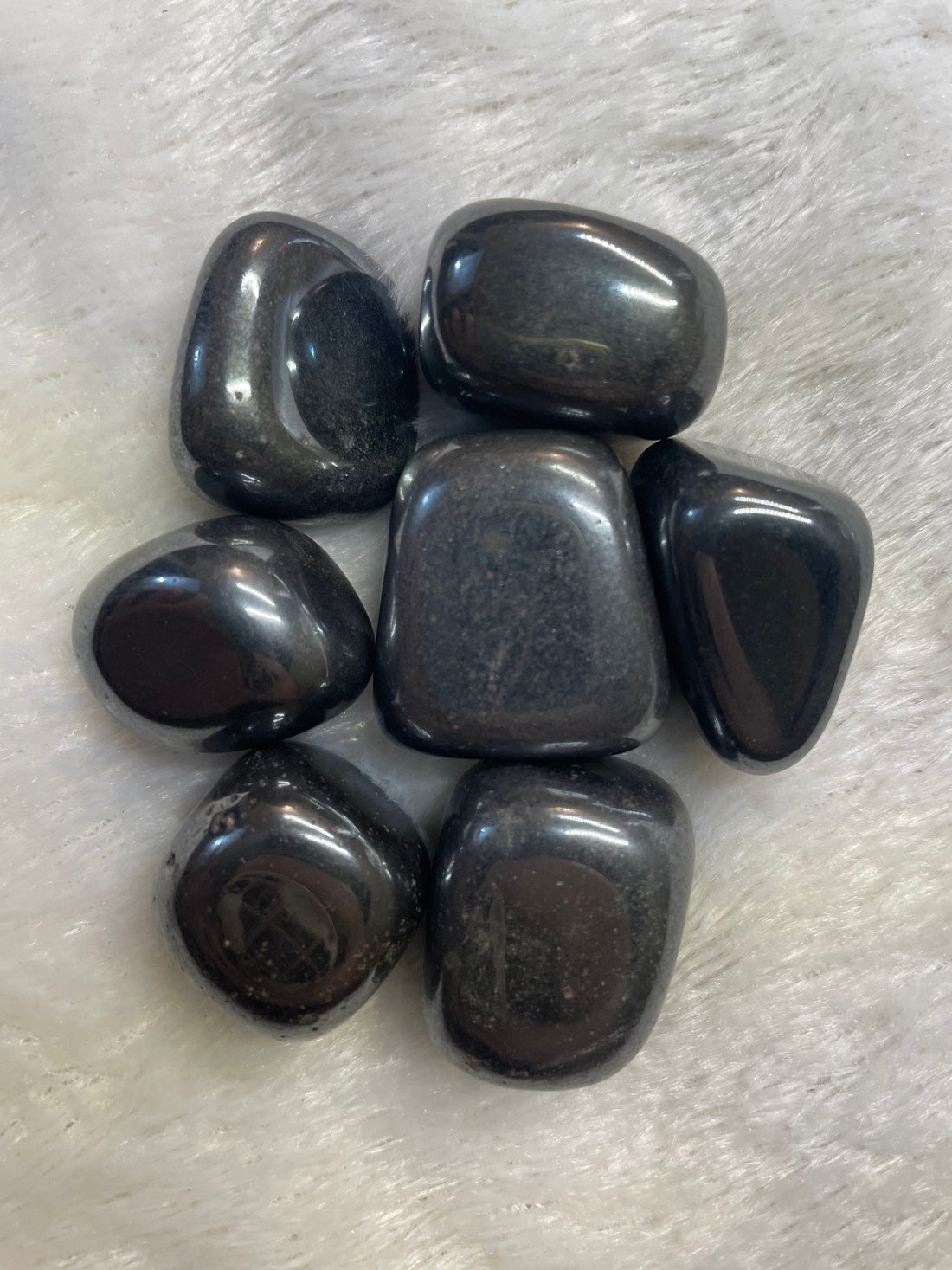 Representative polished gray hematite tumbled stones; each order includes one stone.