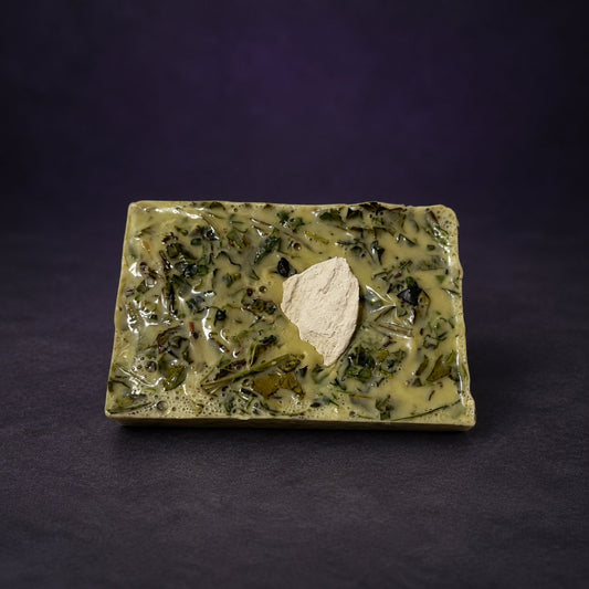 MataBrujo 21 Herb Soap, unwrapped olive green bar with embedded herbs.